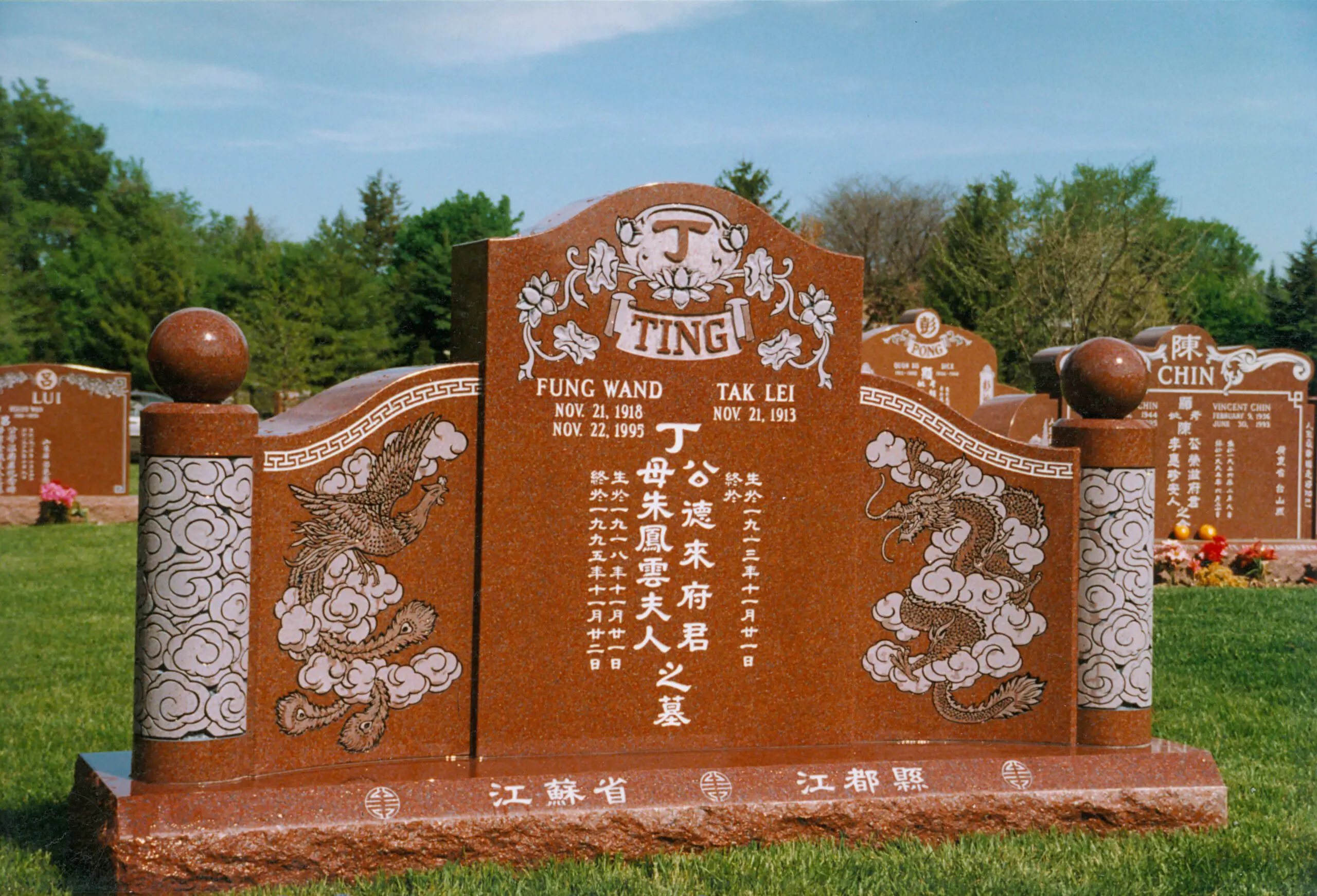 Large, orange, ethnic, Asian granite memorial gravestone