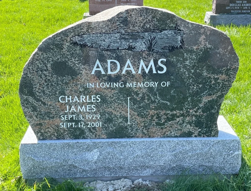 A black granite memorial in a cemetery