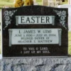 Black granite headstone with sculpted flowers