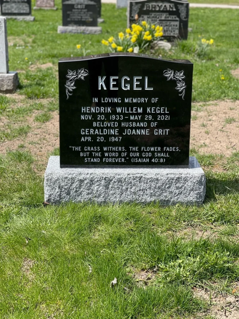 Black granite memorial with maple leaves