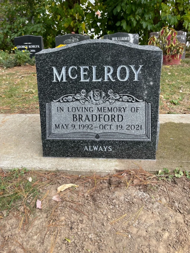 Custom grey granite memorial with a book