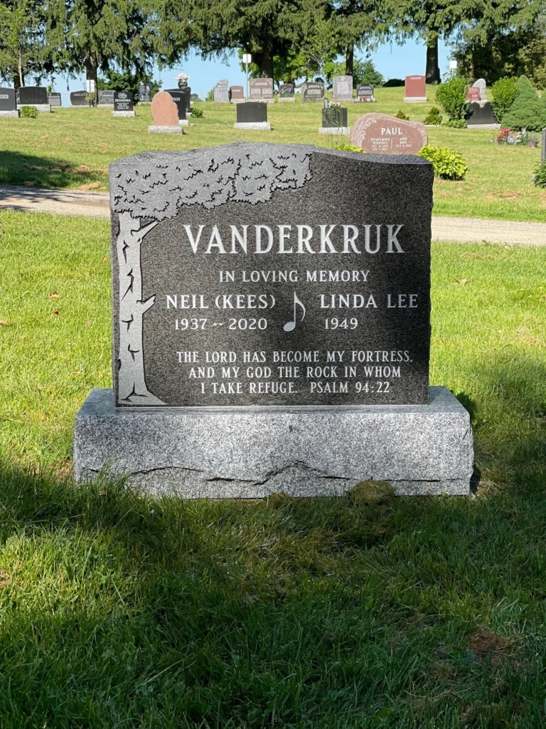 Black granite headstone with a tree