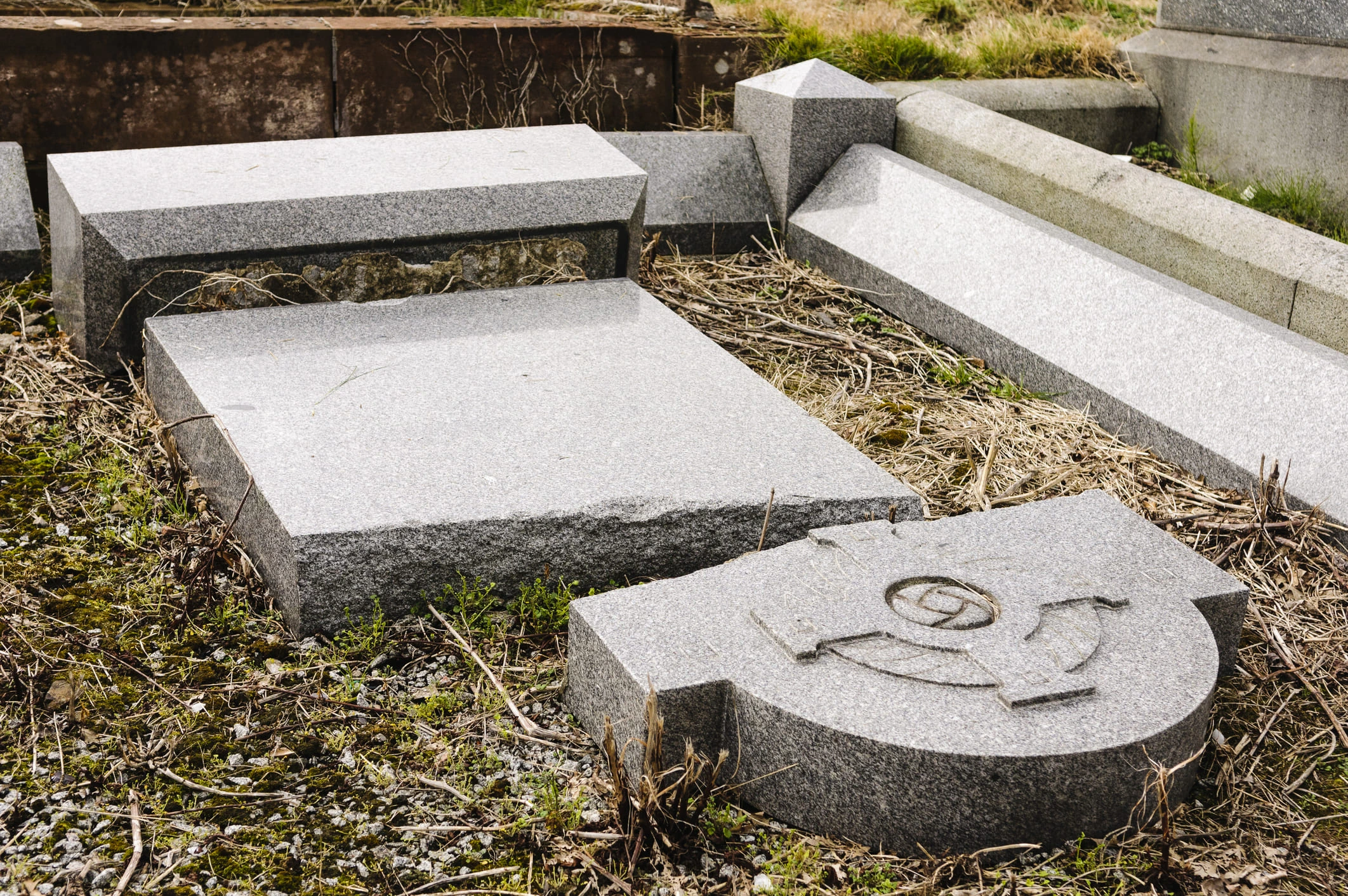 A broken granite cemetery memorial or monument